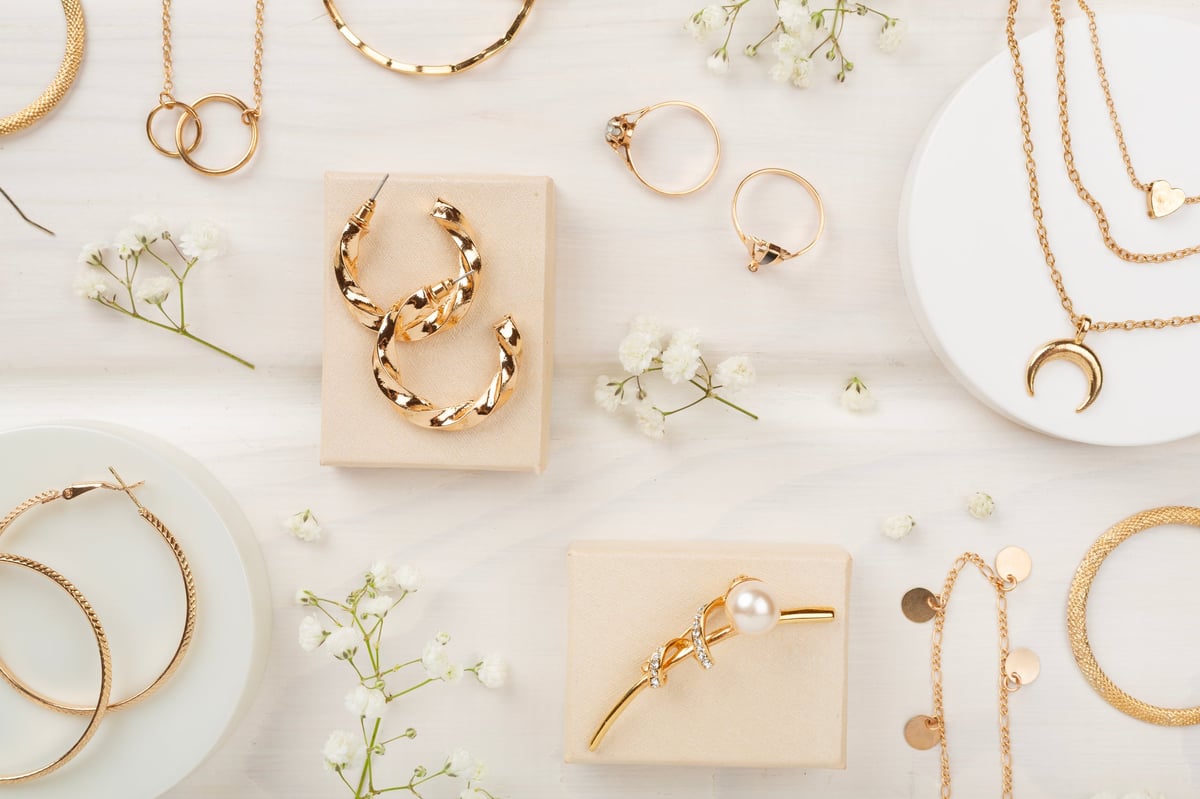 Elegant golden jewelry with decoration on wooden background
