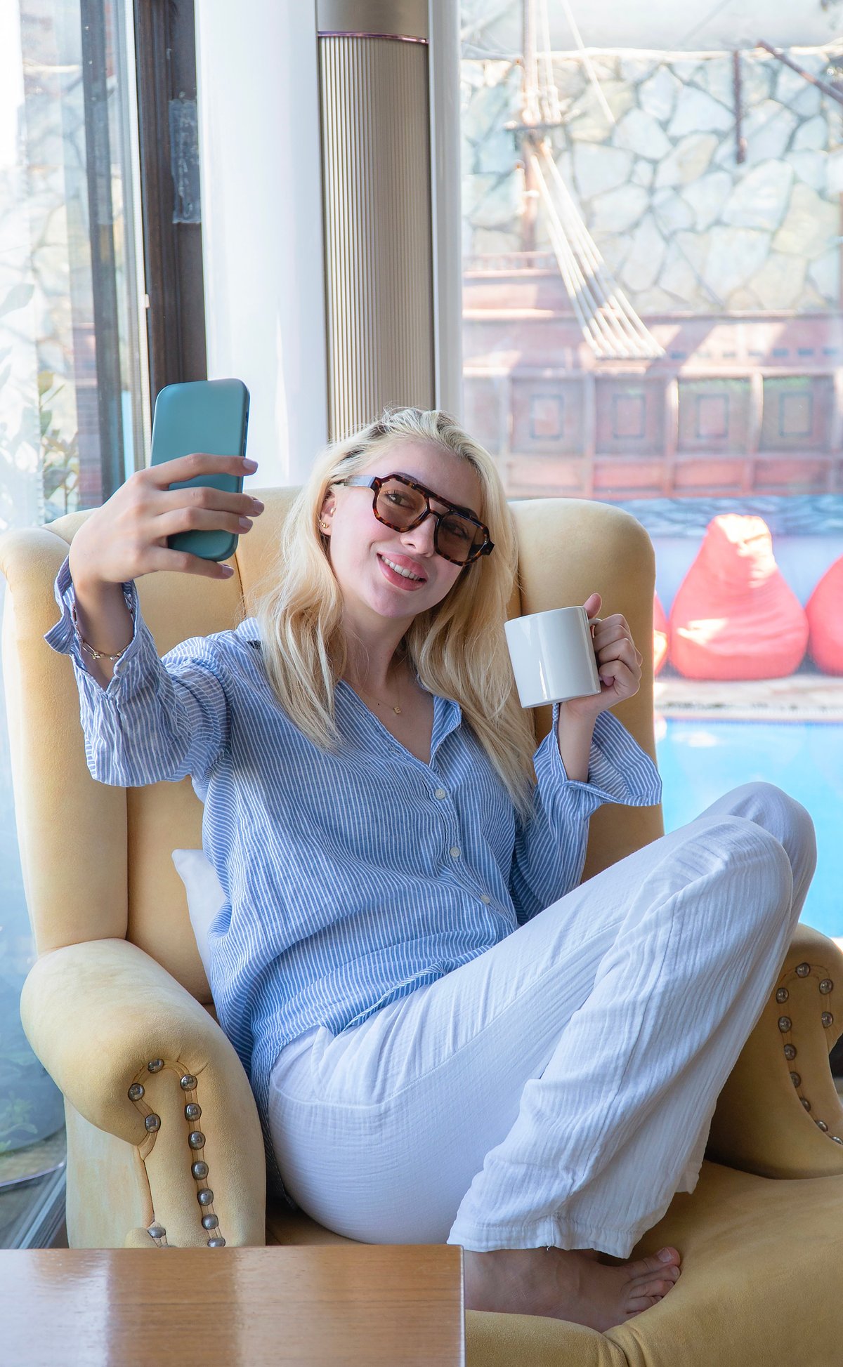 A blonde woman wearing matching blue loungewear pants and shirt